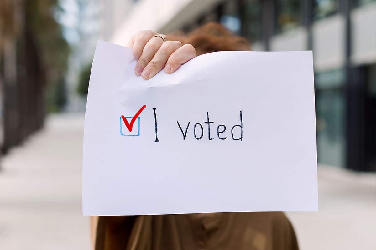 person holding an I voted paper